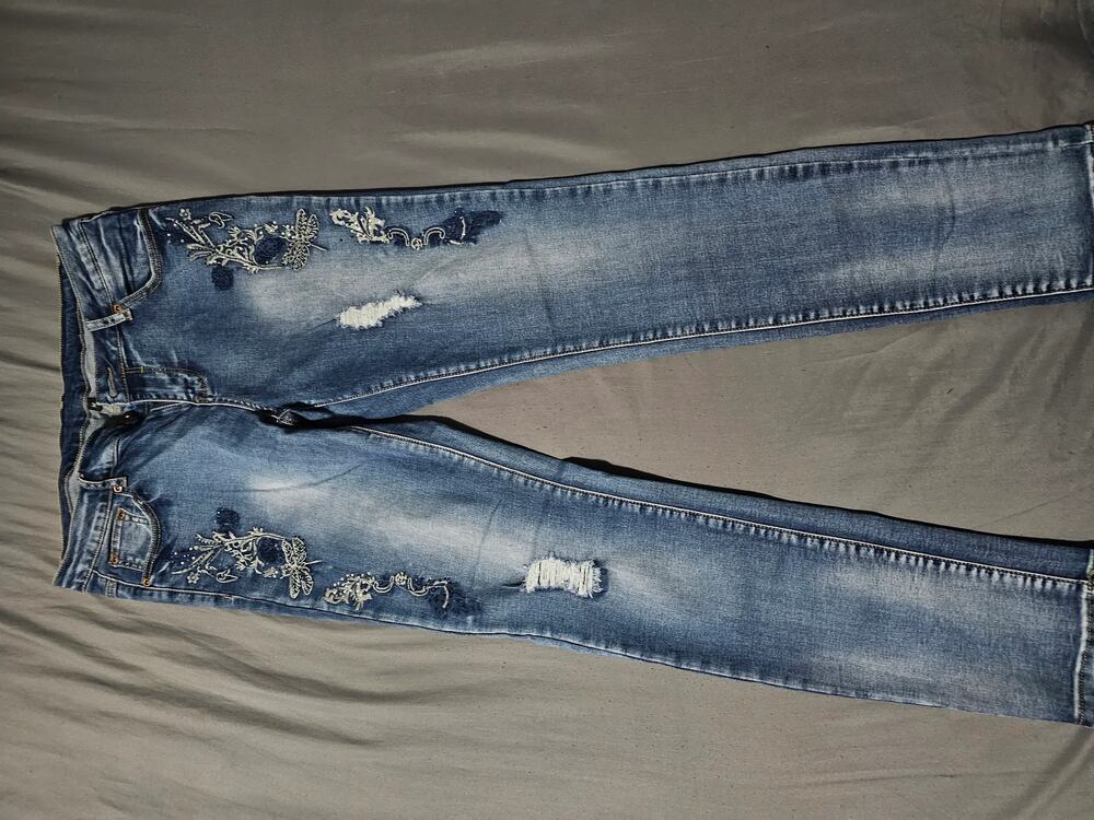 Medium wash denim jeans with contrast stitching five pocket zip fly